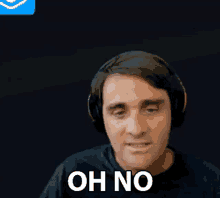 a man wearing headphones says " oh no " in front of a dark background