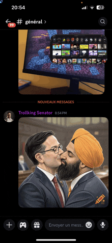 a phone screen shows two men kissing in front of a computer