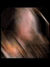 a close up of a person 's face with a blurred image of their face