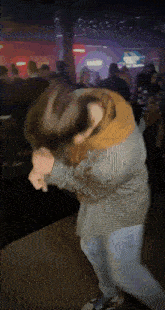 a blurry photo of a person dancing in a club