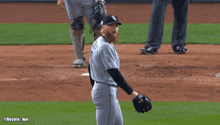 a baseball player wearing a chicago jersey stands on the field