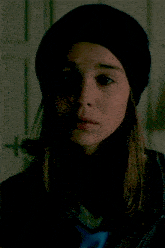 a close up of a woman wearing a hat