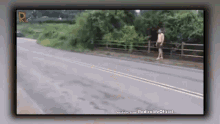 a man without a shirt is walking down a road .