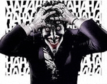 the joker is holding his head in his hands and laughing with his hands on his head .