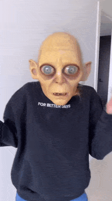 a person wearing a gollum mask and a sweater that says for better days .