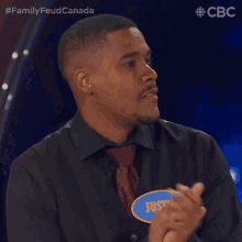 a man wearing a name tag that says justin