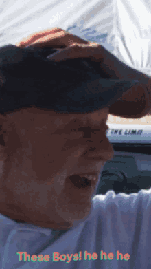 a man wearing a hat with the words " these boys he he he " above him