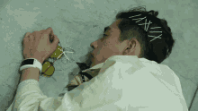 a man laying on the floor with a headband that says ixxx