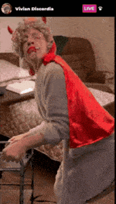 a man in a devil costume is standing in front of a live button
