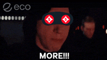 a man with a mask on his eyes is screaming with the words more below him