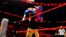 a wrestler is being lifted in the air by another wrestler