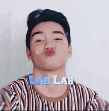 a man making a funny face with lab lab written in blue letters