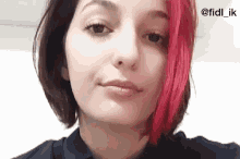 a woman with red hair is making a funny face