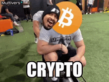 a man wearing a lb prototype shirt sits on another man 's shoulders with a bitcoin symbol on his head