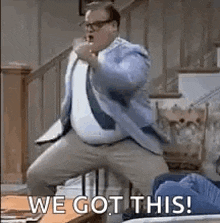 a man in a suit and tie is dancing in a living room with the words `` we got this ! ''