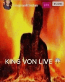 a man is sitting in the middle of a fire with the words `` king von live '' written above him .