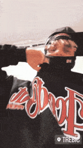a man wearing a black shirt that says good on the back