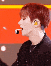 a close up of a person wearing headphones and a microphone .