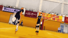 a volleyball game is being played in front of a sign that says ' a '