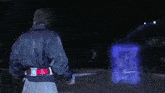 a blue light is coming out of a cube in the dark