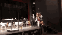 a band is performing on stage with a sign that says band festival
