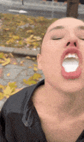 a close up of a woman 's mouth with her eyes closed
