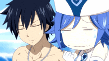 a boy and a girl are standing next to each other and the girl is wearing a white hat with a heart on it