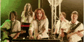 a group of people are playing instruments including a man who is playing a keyboard