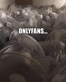 a bunch of fans are stacked on top of each other with the words onlyfans below them