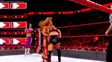a woman is wrestling another woman in a wrestling ring