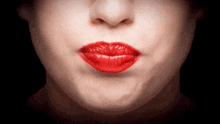 a close up of a woman 's face with red lips