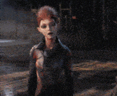 a woman with red hair is standing in a dark room and says i 'll wave to ya from the finish line