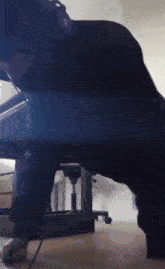 a person is doing push ups under a desk with headphones on