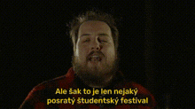 a man with a beard and mustache is talking in a foreign language
