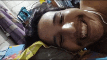 a woman is laying on a bed and smiling .