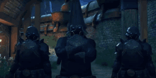 a group of soldiers are standing in front of a building