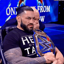 roman reigns leans forward universal champion get up from seat serious