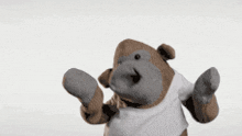 a stuffed monkey wearing a white t-shirt is dancing