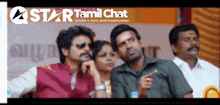 a group of people are standing in front of a star tamil chat sign
