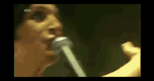 a close up of a woman singing into a microphone with wdr written on the bottom