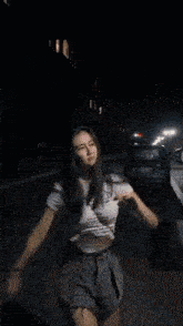 a woman is dancing in front of a neon sign that says texaco