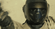 a close up of a person wearing a helmet and a gas mask