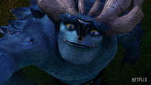a close up of a blue monster with horns and a netflix logo