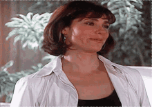 a woman wearing a white shirt and a black top