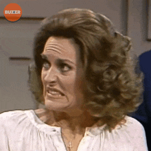 a close up of a woman 's face with buzzr written on the bottom