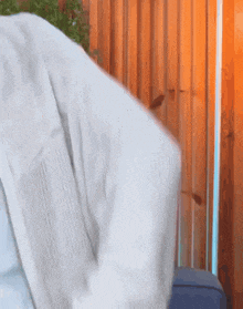 a close up of a person 's arm in front of a wooden wall .