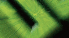 a green and black background with a swirl in the center