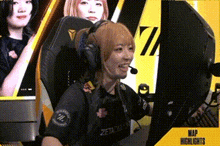 a woman wearing a headset is sitting in front of a computer monitor .