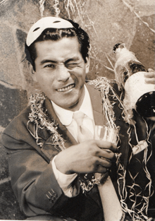 a man wearing a mask and holding a bottle of champagne