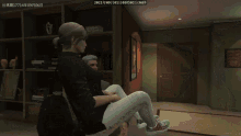 a screenshot of a video game shows a woman sitting in a chair